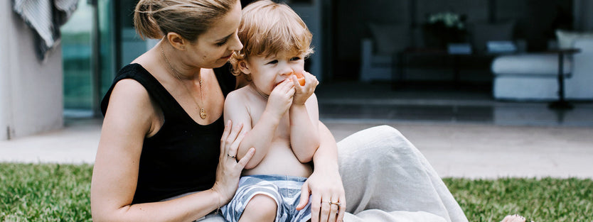 toddler eating in mums lap