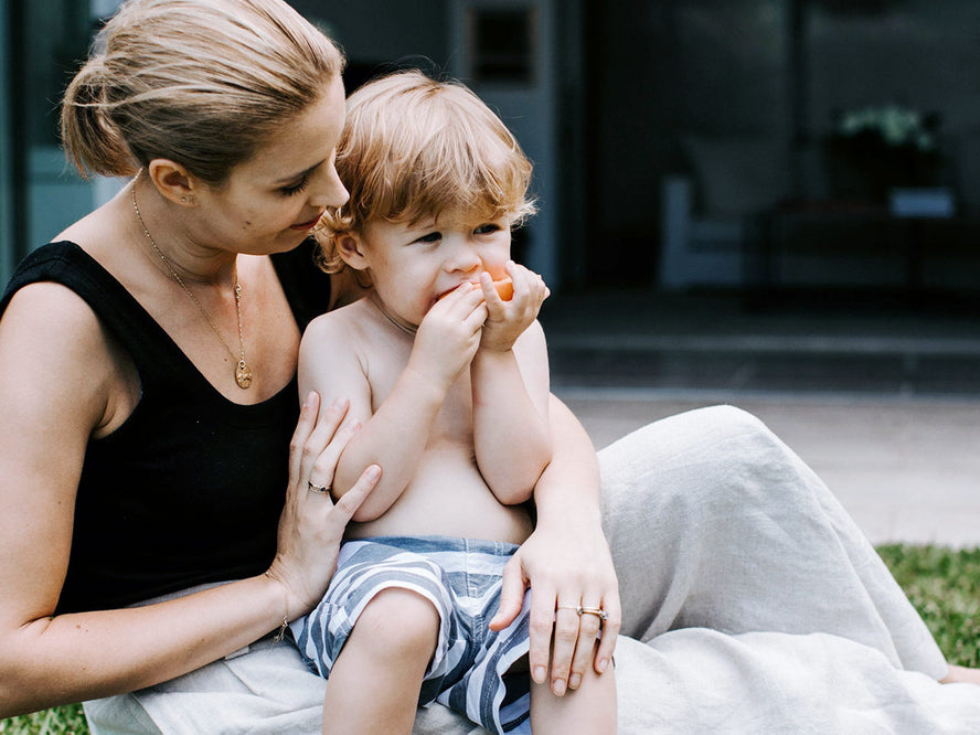 toddler eating in mums lap