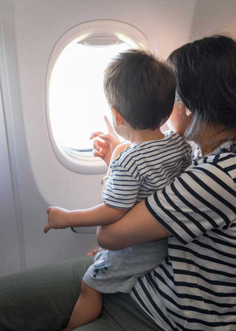 Mother and son looking out of plane window