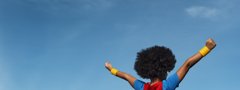 Child outside in a cape