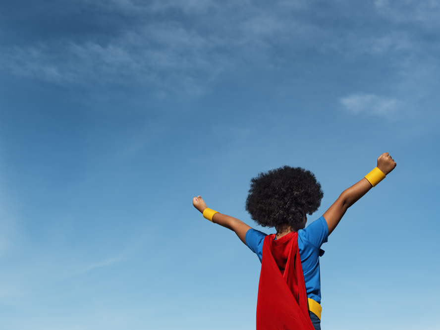 Child outside in a cape