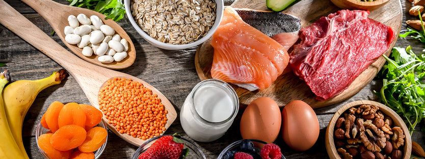 Portions of grains, meat, salmon, eggs, avocado, berries, bananas, nuts and legumes