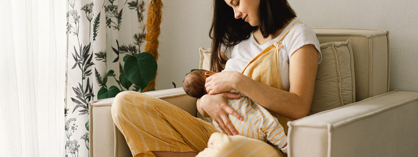 Woman breastfeeding on chair