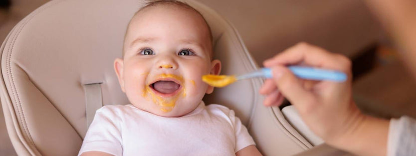 Baby being fed with a spoon.