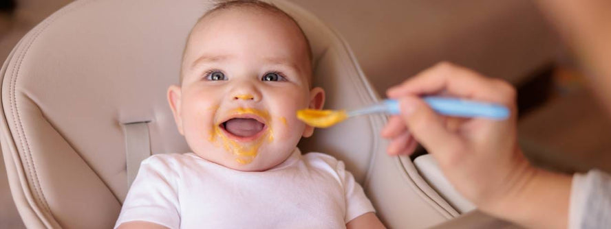 Baby being fed with a spoon.