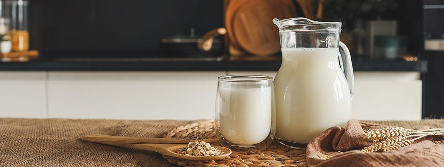 Jar and glass of milk on a kitchen bench