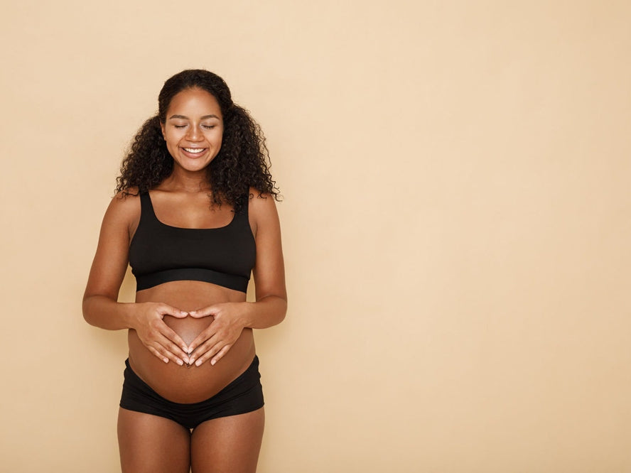 Woman holding pregnant tummy