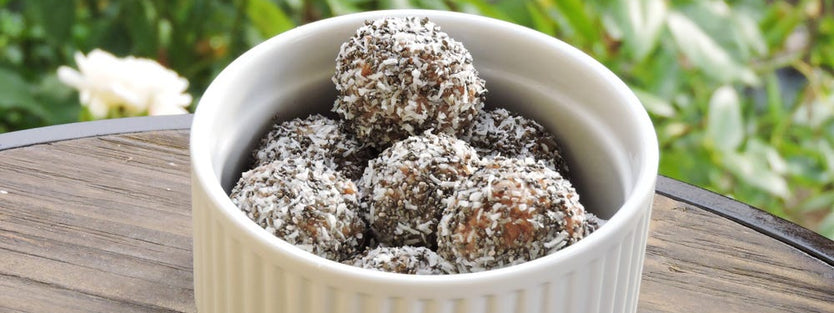 chocolate bliss balls with coconut on outside