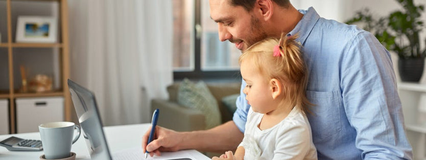 man doing work on bench with toddler