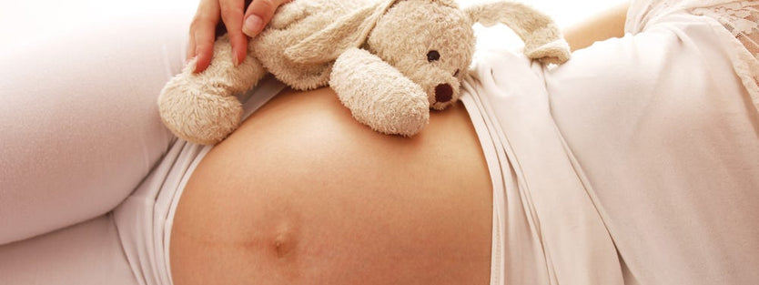 Pregnant mum on bed