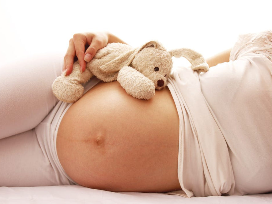 Pregnant mum on bed