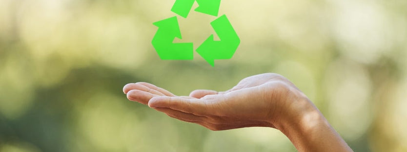 Recycle logo over someone's hand 