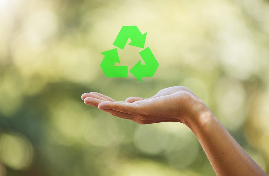 Recycle logo over someone's hand 