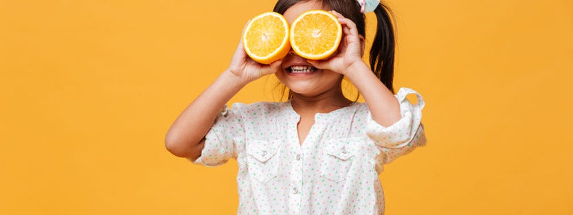 Child holding orange