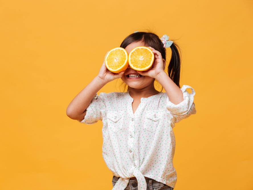 Child holding orange