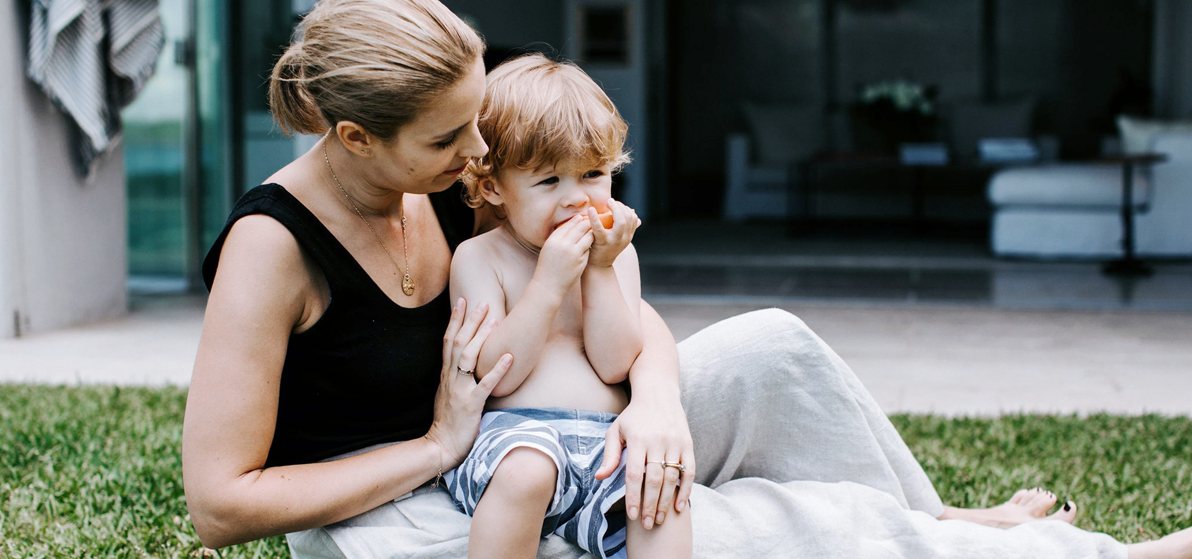 toddler eating in mums lap