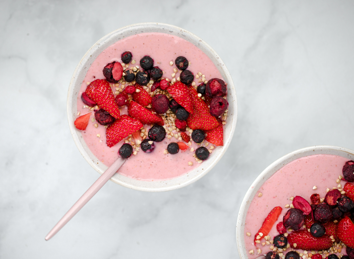 smoothie bowl topped with berries and granola 