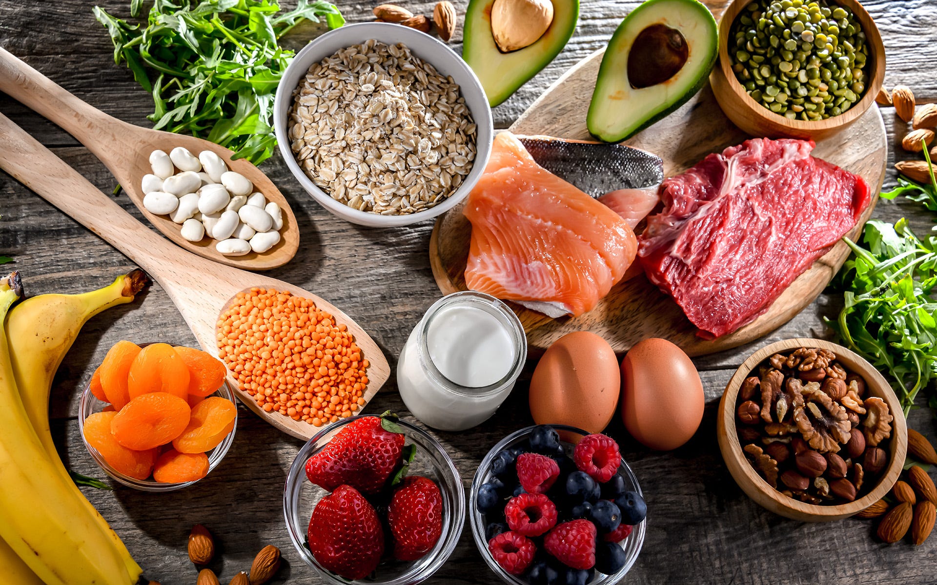 Portions of grains, meat, salmon, eggs, avocado, berries, bananas, nuts and legumes
