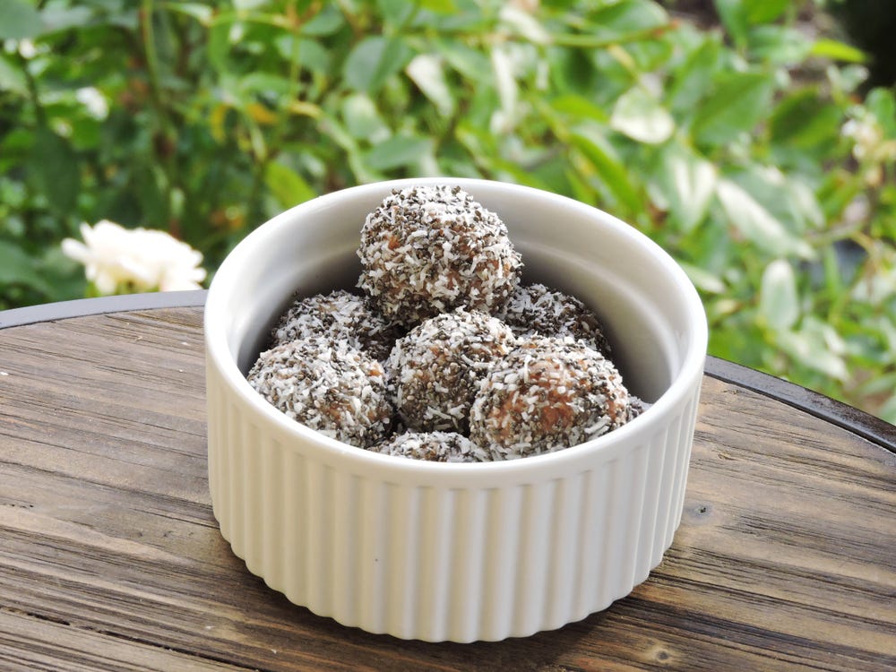 chocolate bliss balls with coconut on outside 