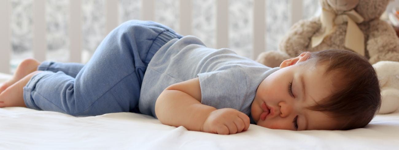 Baby sleeping in cot